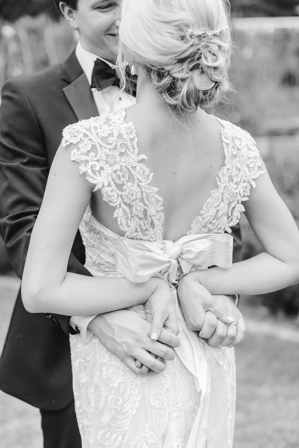 bride and groom holding hands, bride wearing an Anna Campbell wedding gown