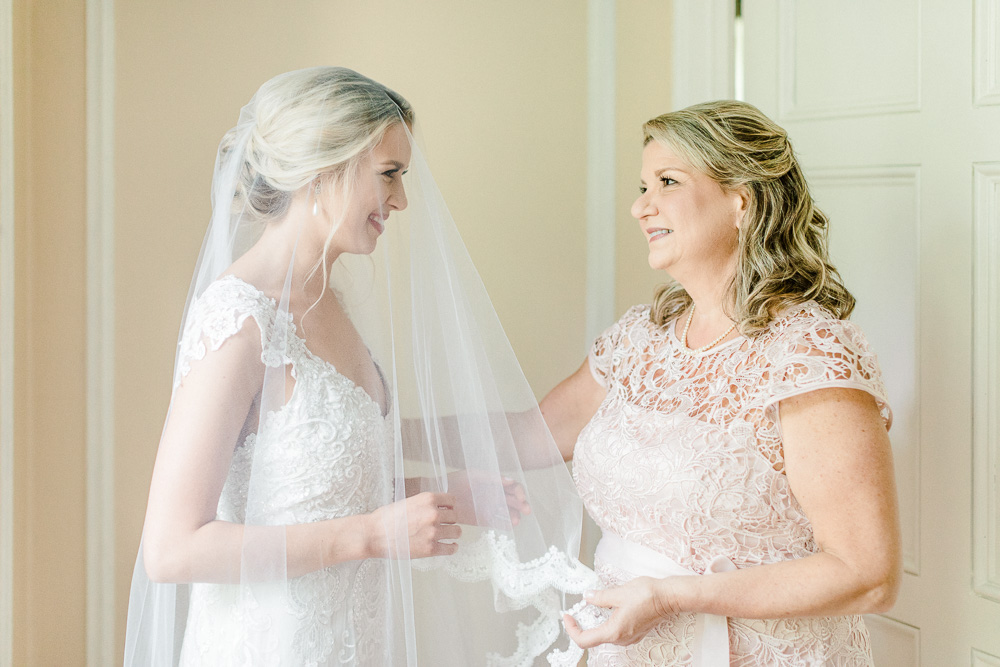bride and mother smiling on wedding day