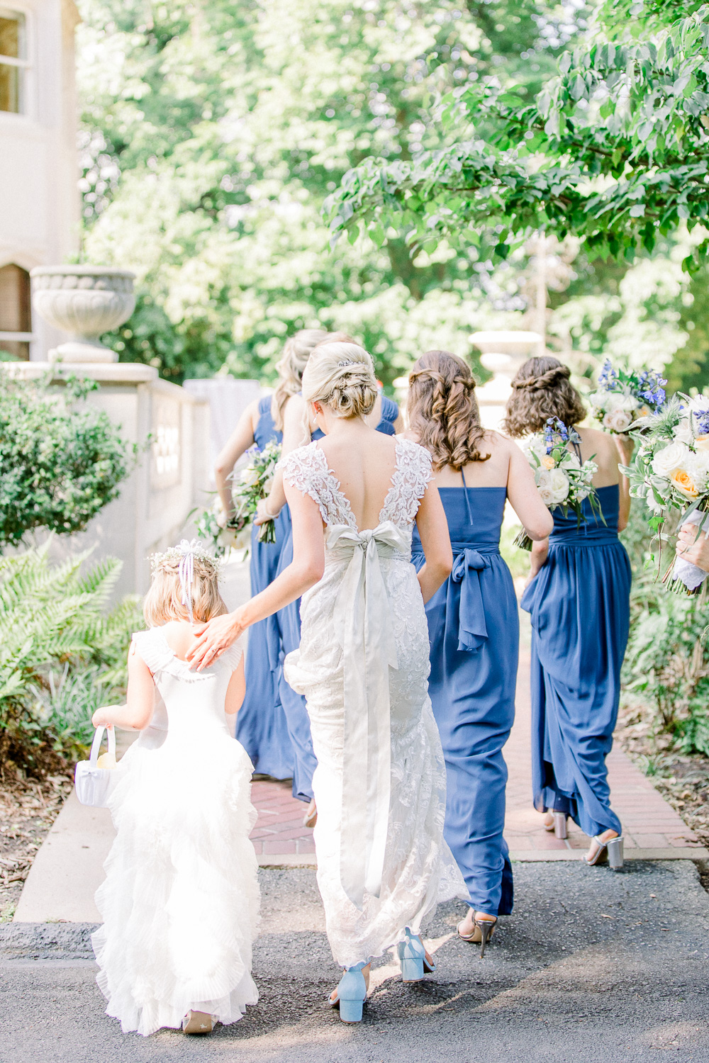 bride, bridesmaids and flower girl walking away at callanwolde
