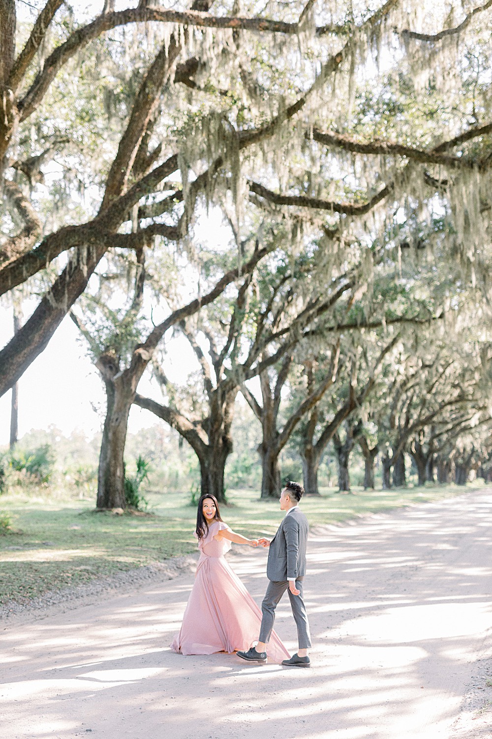 couple walking through wormsloe's entrance in Savannah