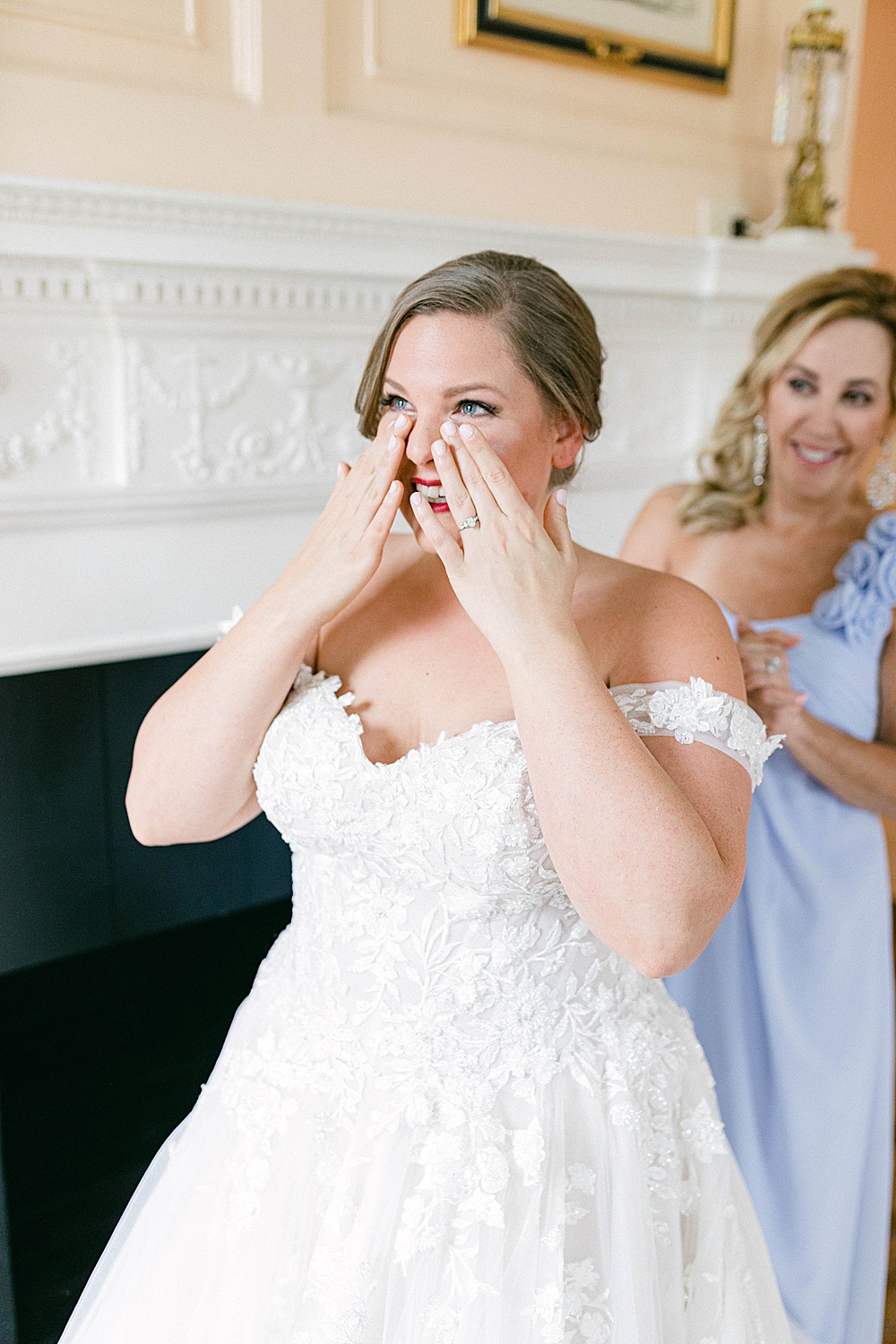 bride getting emotional as she puts on her wedding dress
