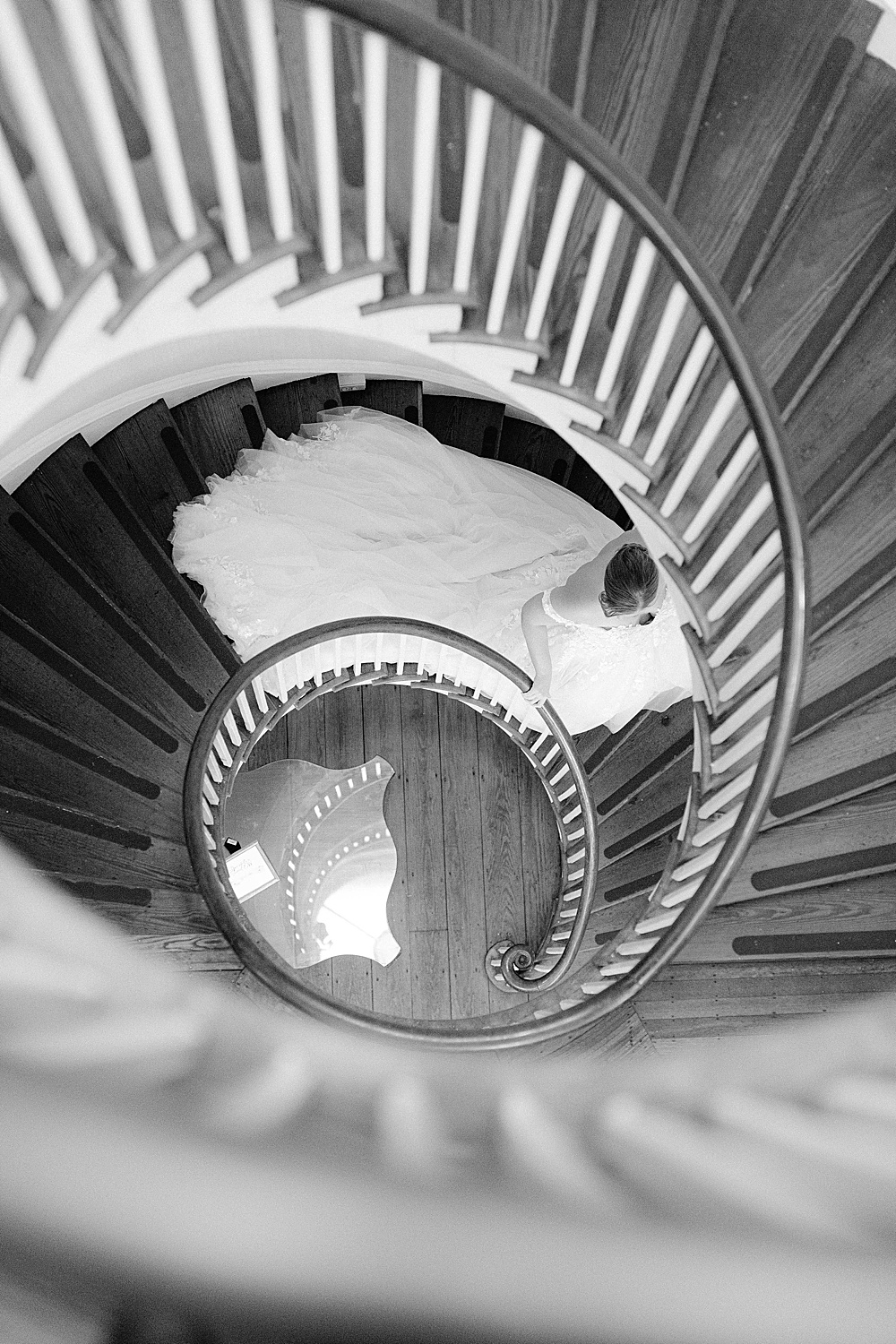 bride walking down spiral staircase at Lowndes Grove Plantation