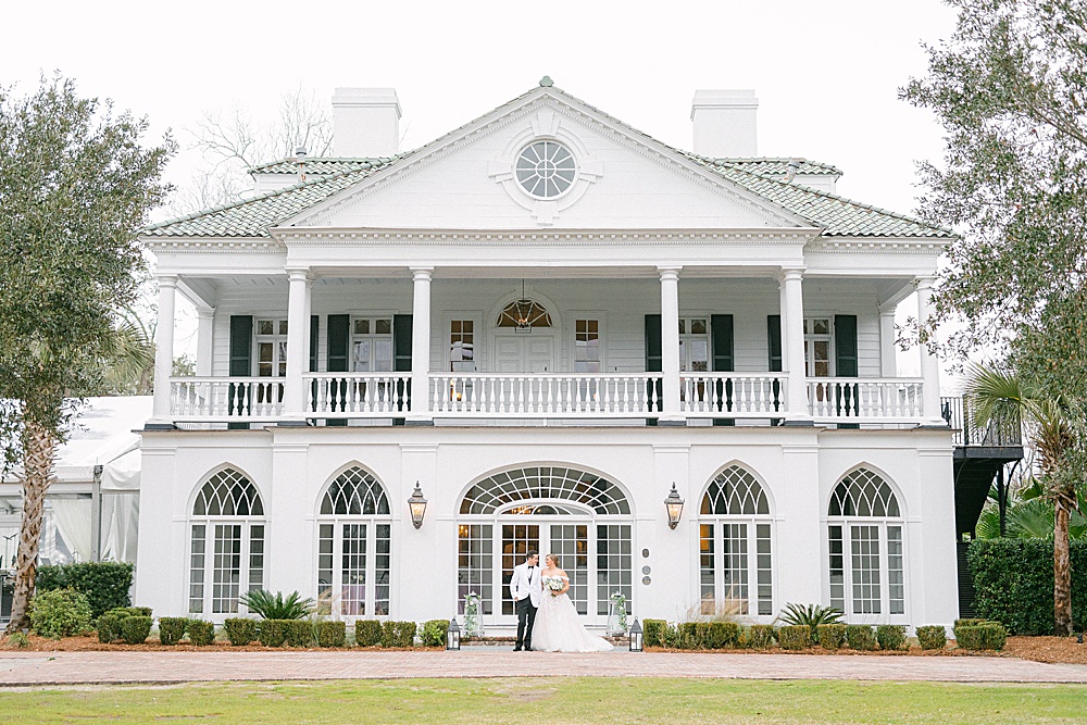 wedding couple standing in front of Lowndes Grove Plantation