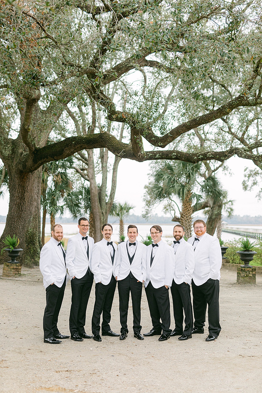 groomsmen in white tux jackets at Lowndes Grove Plantation
