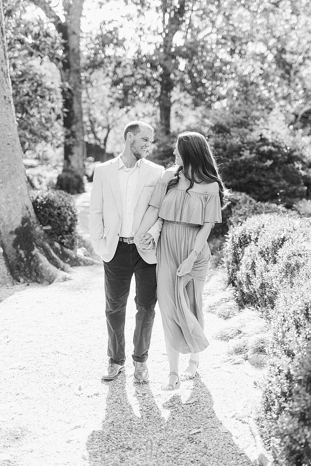 black and white photo of a couple walking through the Callaway Gardens