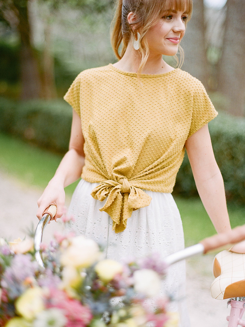 bride wearing a yellow front-tied shirt for her engagement session