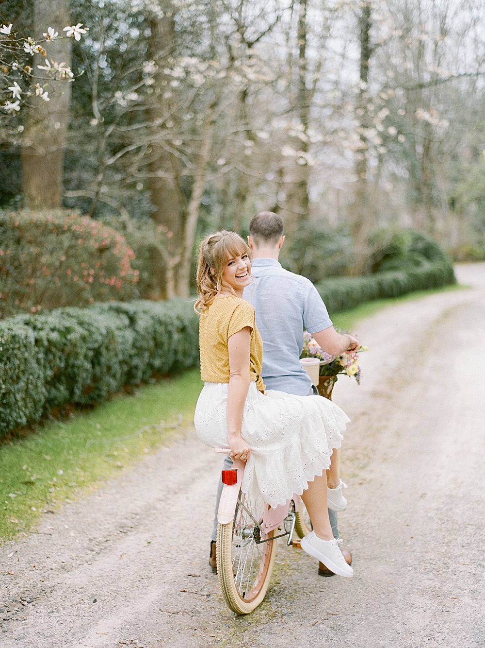 Engagement portraits with a couple riding on their pink bike at Meadowlark 1939