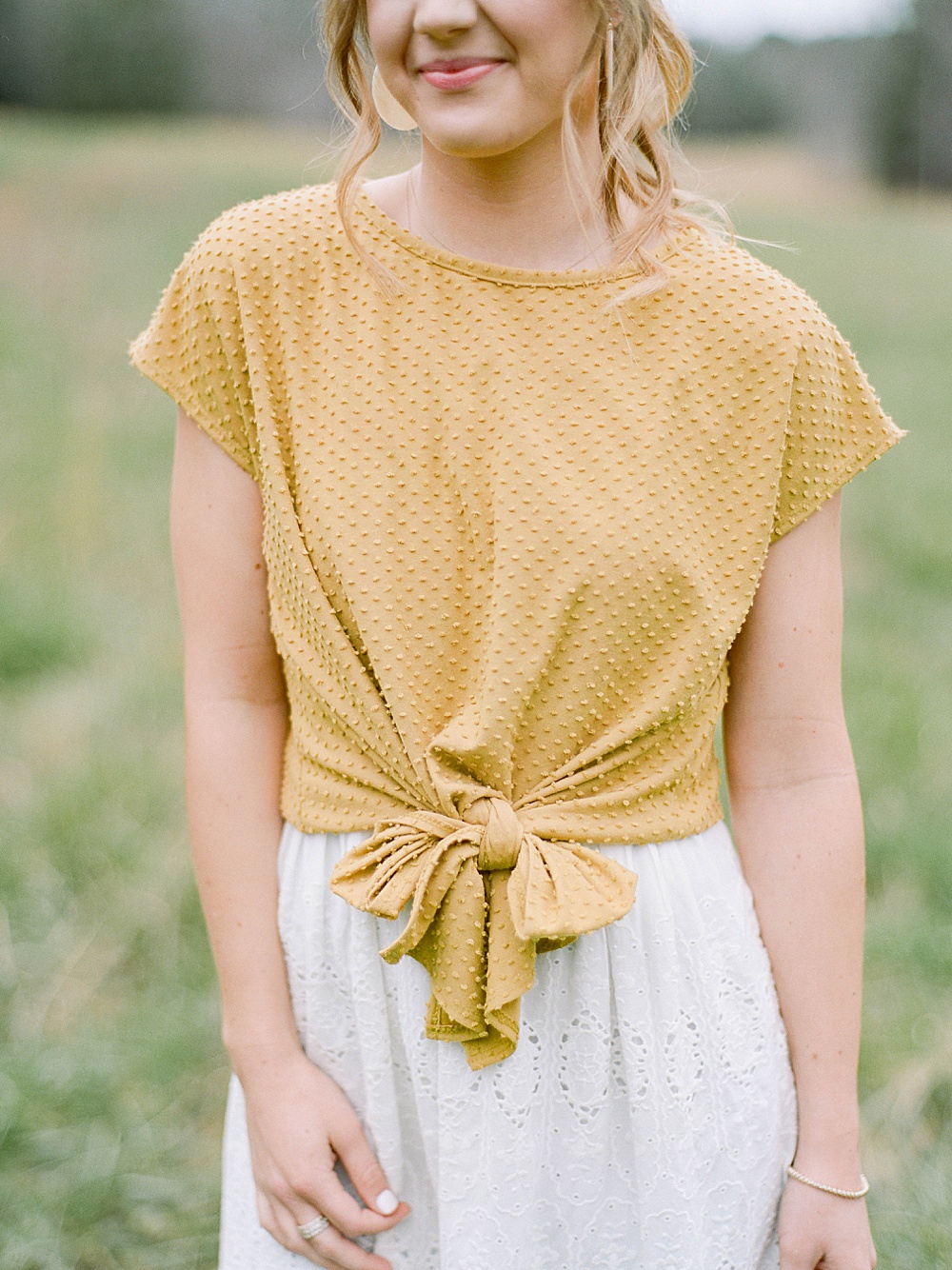 yellow polka dot shirt with a tie on the front and white skirt