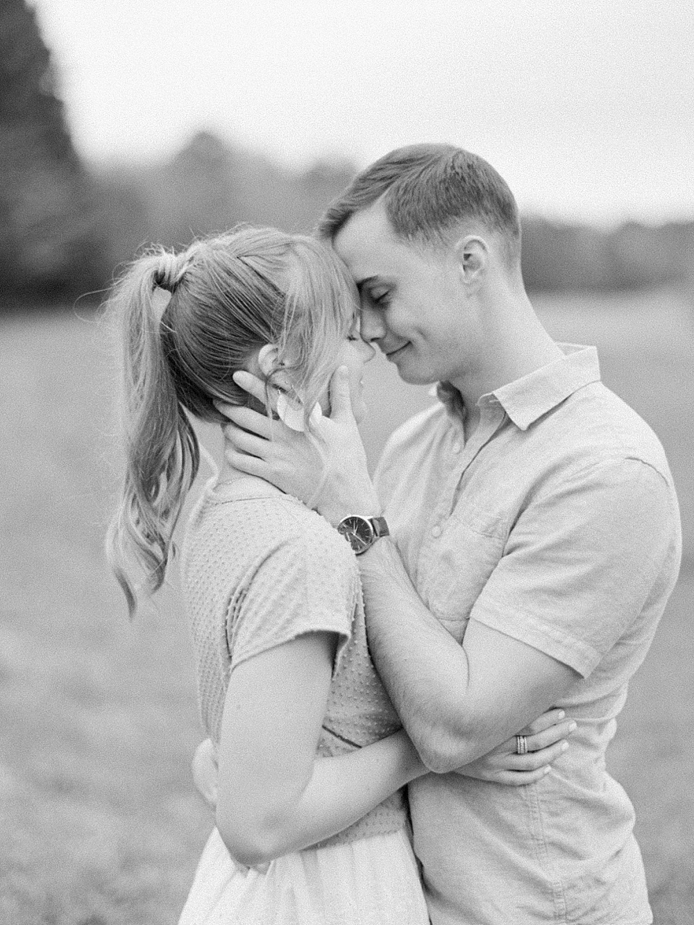 romantic black and white photo of a couple posing forehead to forehead