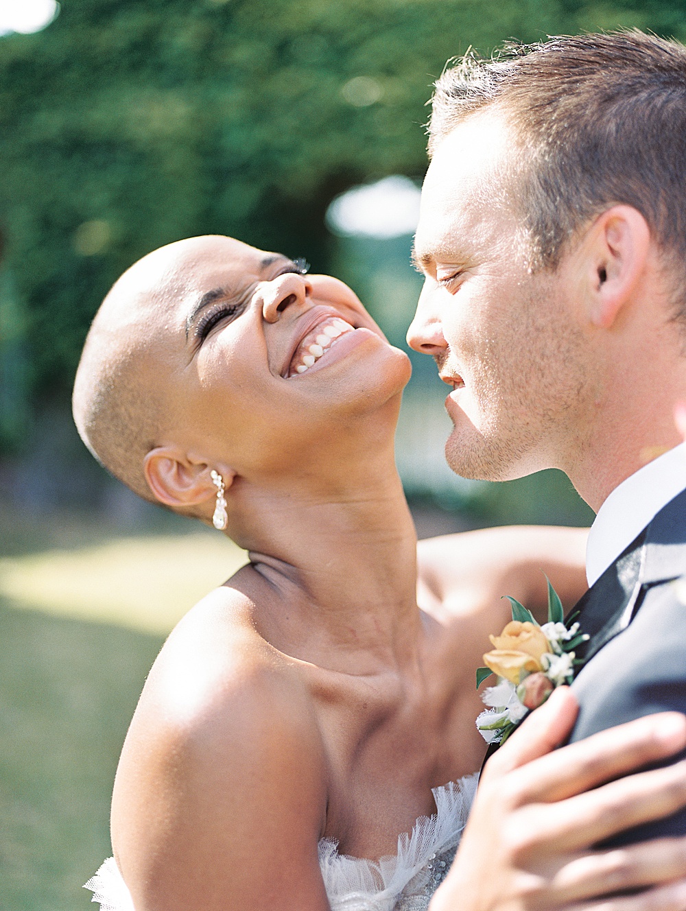 Bald bride laughing with her groom