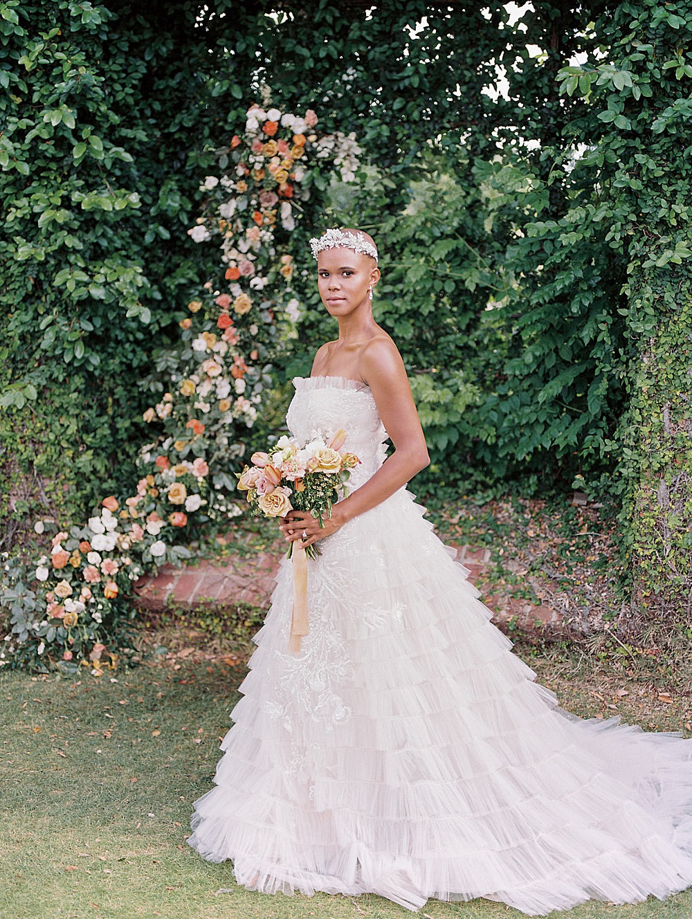 Bride standing in front of floral installation at The Bibb Mill