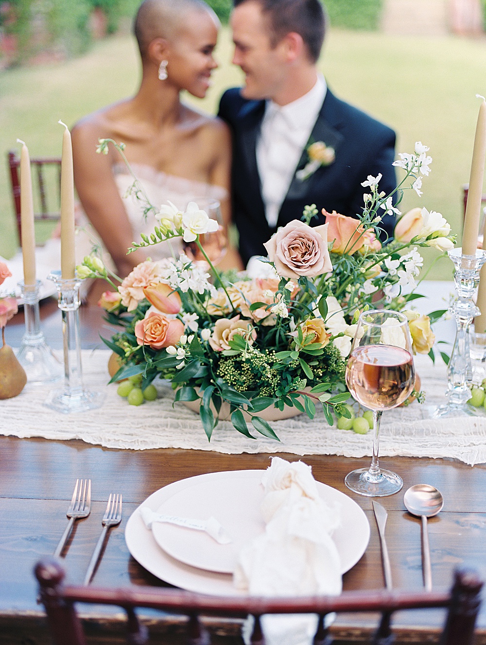 blush, gold and orange floral arrangement on a reception table