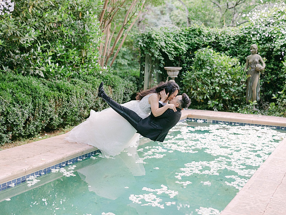 Wedding couple dive into pool after their ceremony
