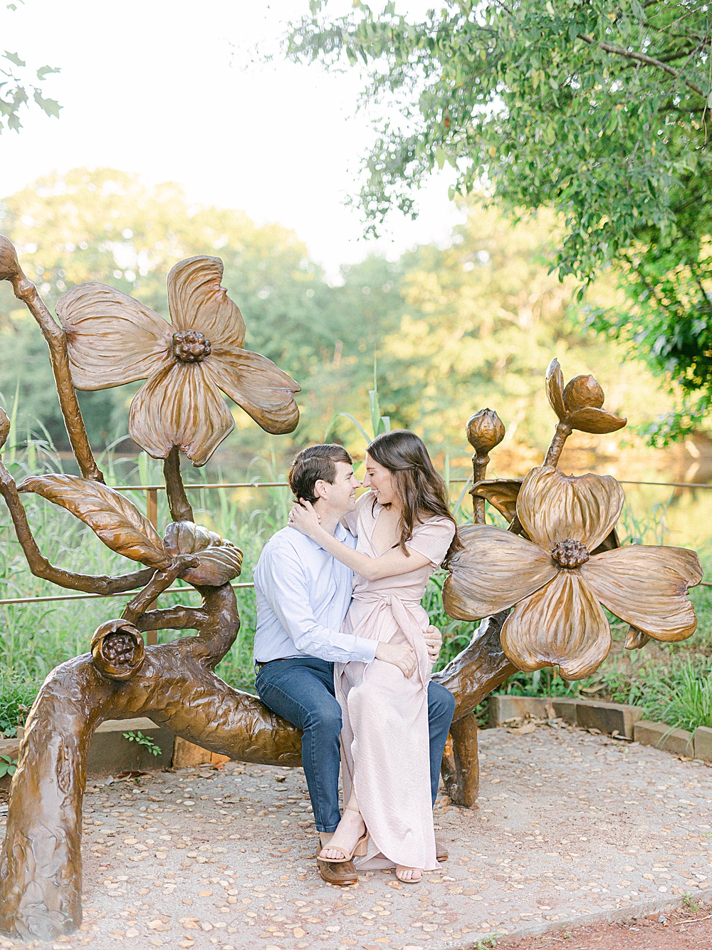 Couples session on dogwood statue in Piedmont Park
