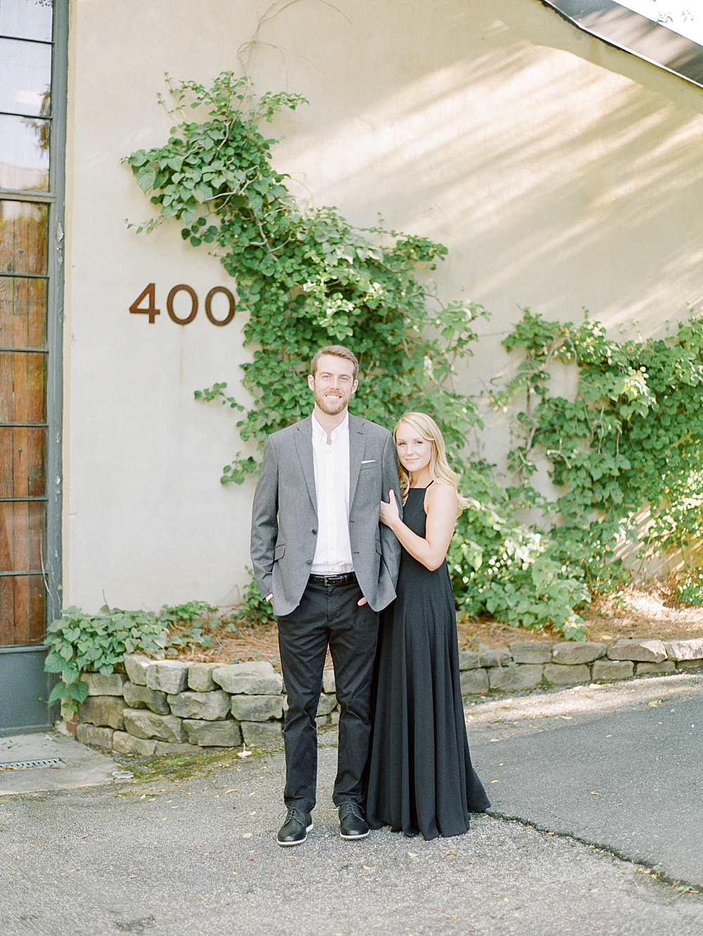 Girl wearing black dress and guy wearing suit for their engagement outfit