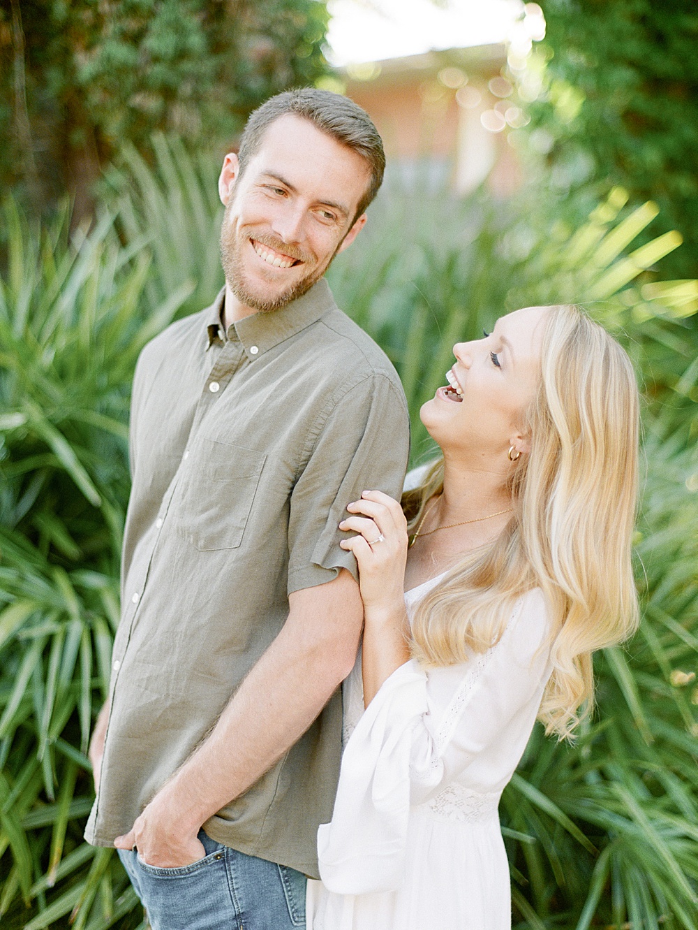 Guy and girl laughing during engagement photos