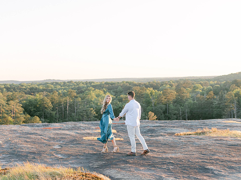 Sunset engagement photos on Arabia Mountain with a long dress