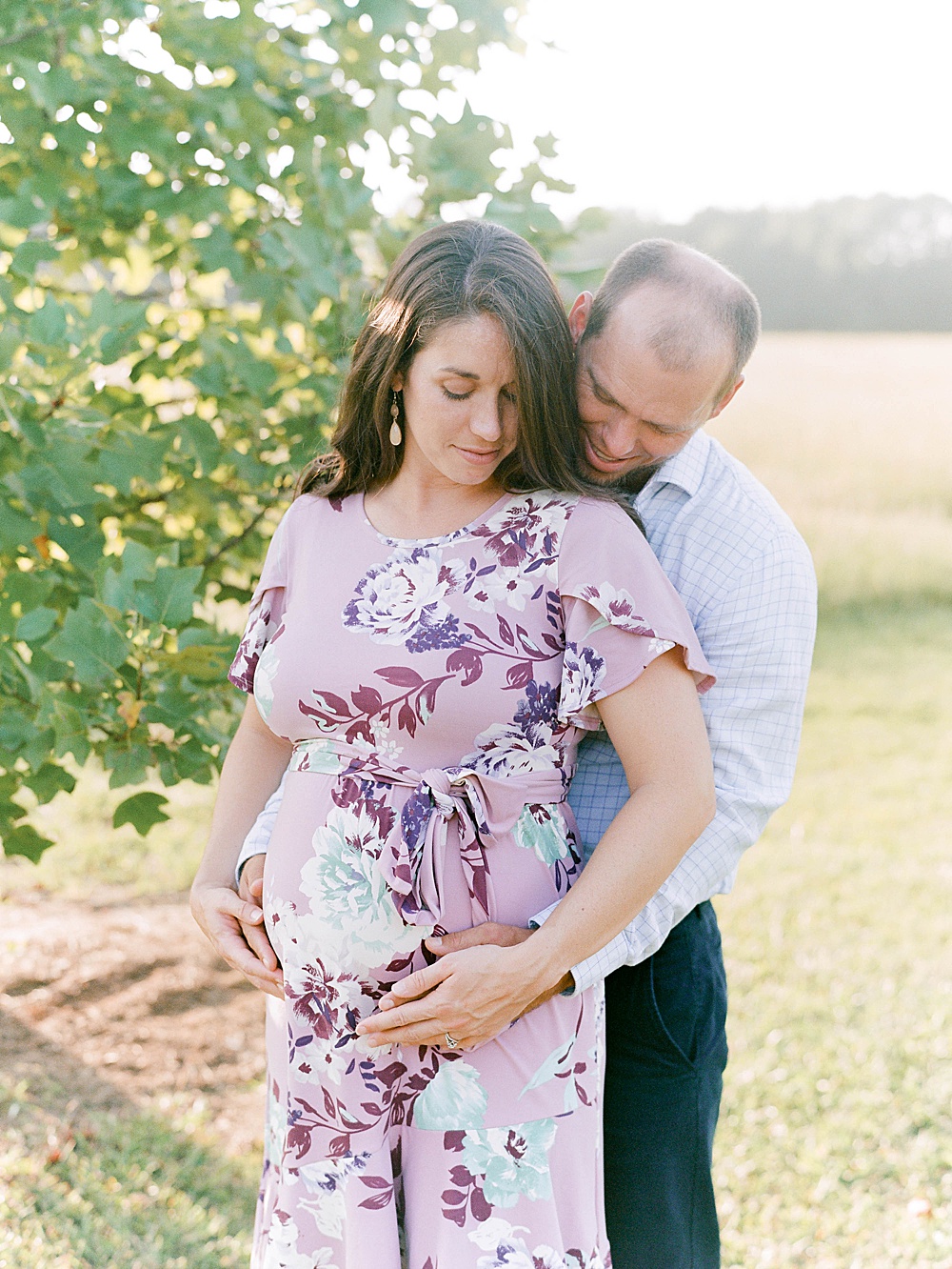 Couple expecting their first baby hugging
