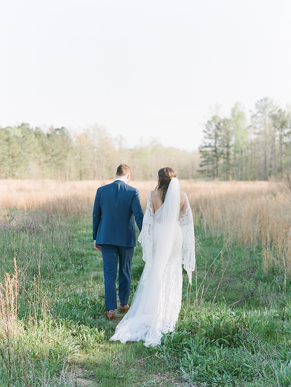 Bride and groom in field at Serenbe