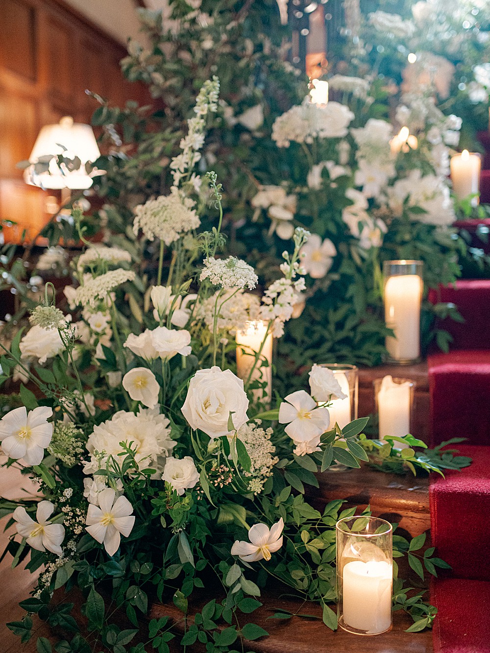 White and green florals with candles for a ceremony at Callanwolde