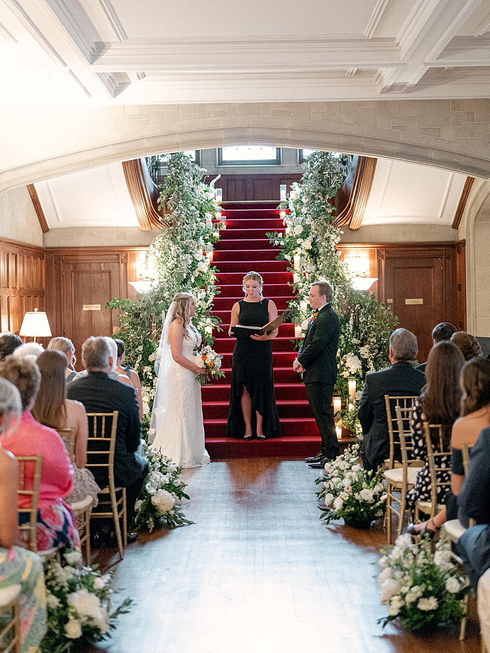 Indoor wedding ceremony in front of staircase at Callanwolde Fine Arts Center