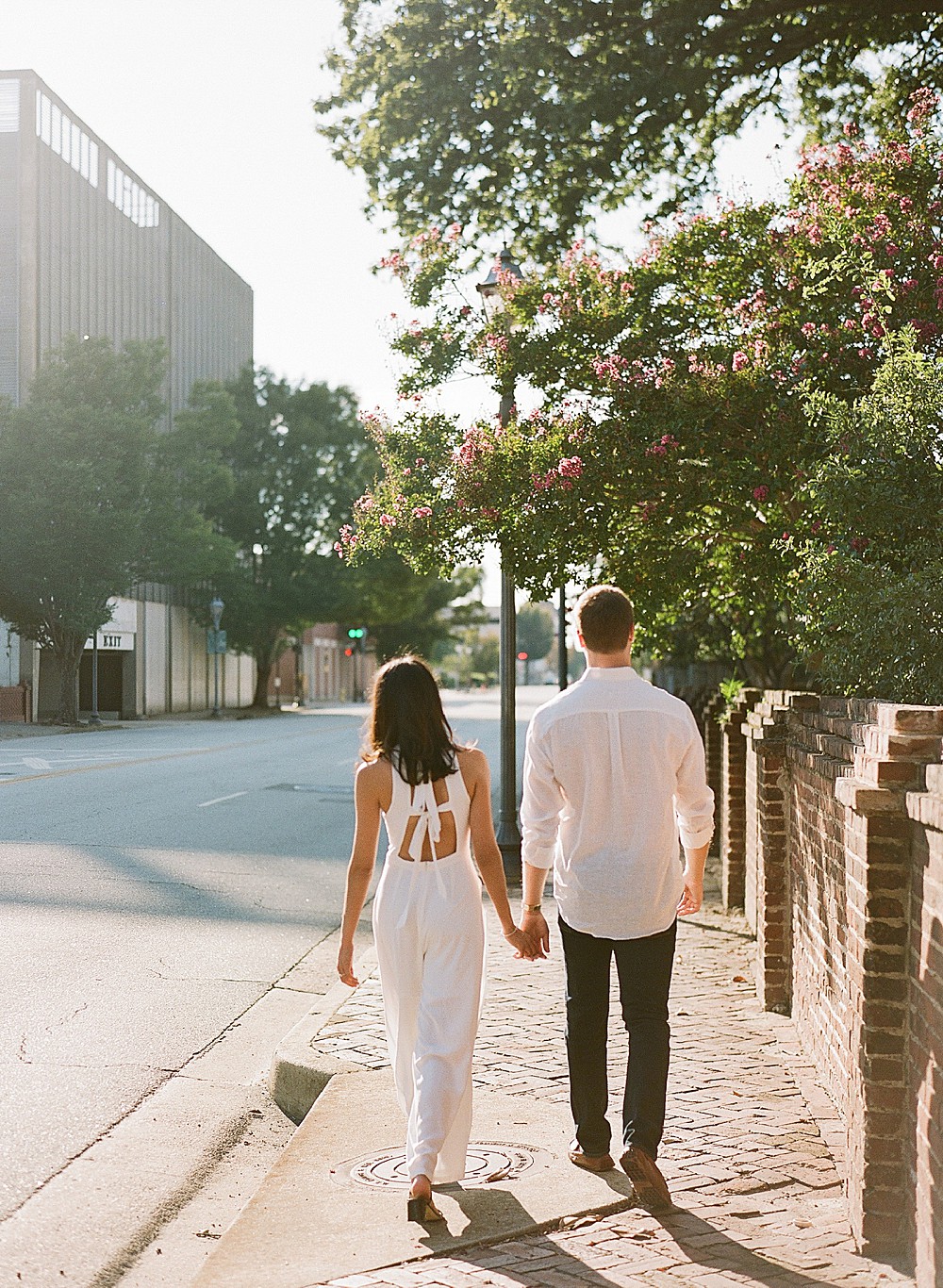 Couple holding hands and walking in downtown Augusta, Georgia
