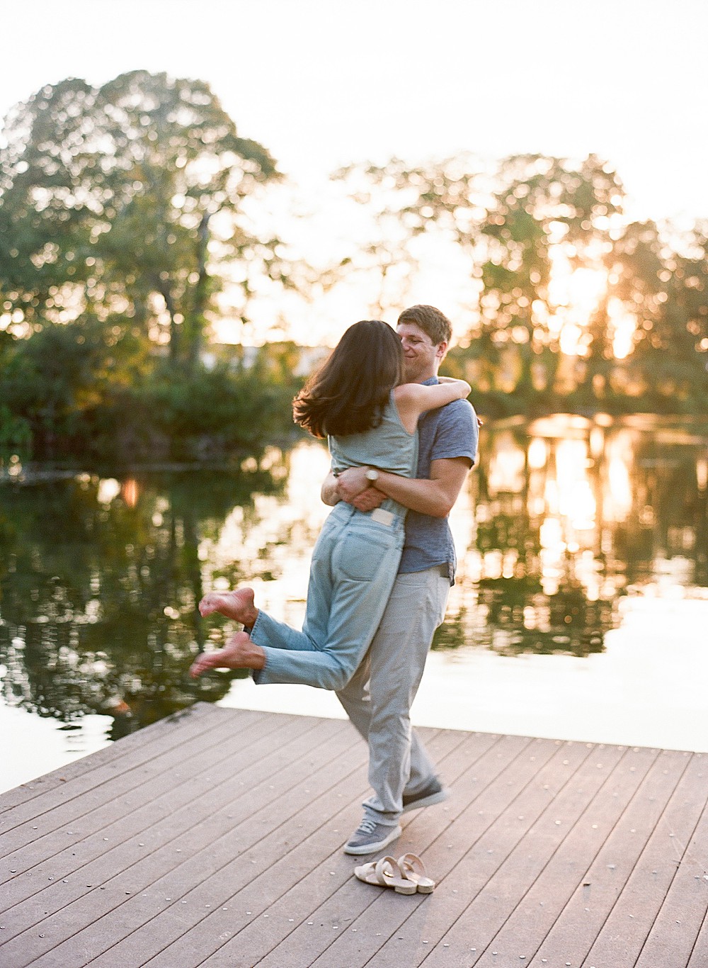 Couple doing The Notebook kiss at Brick Pond dock
