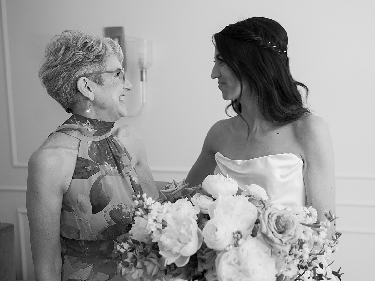 Black and white image of mother of the bride talking to her daughter, the bride, in a sweet pre-ceremony moment