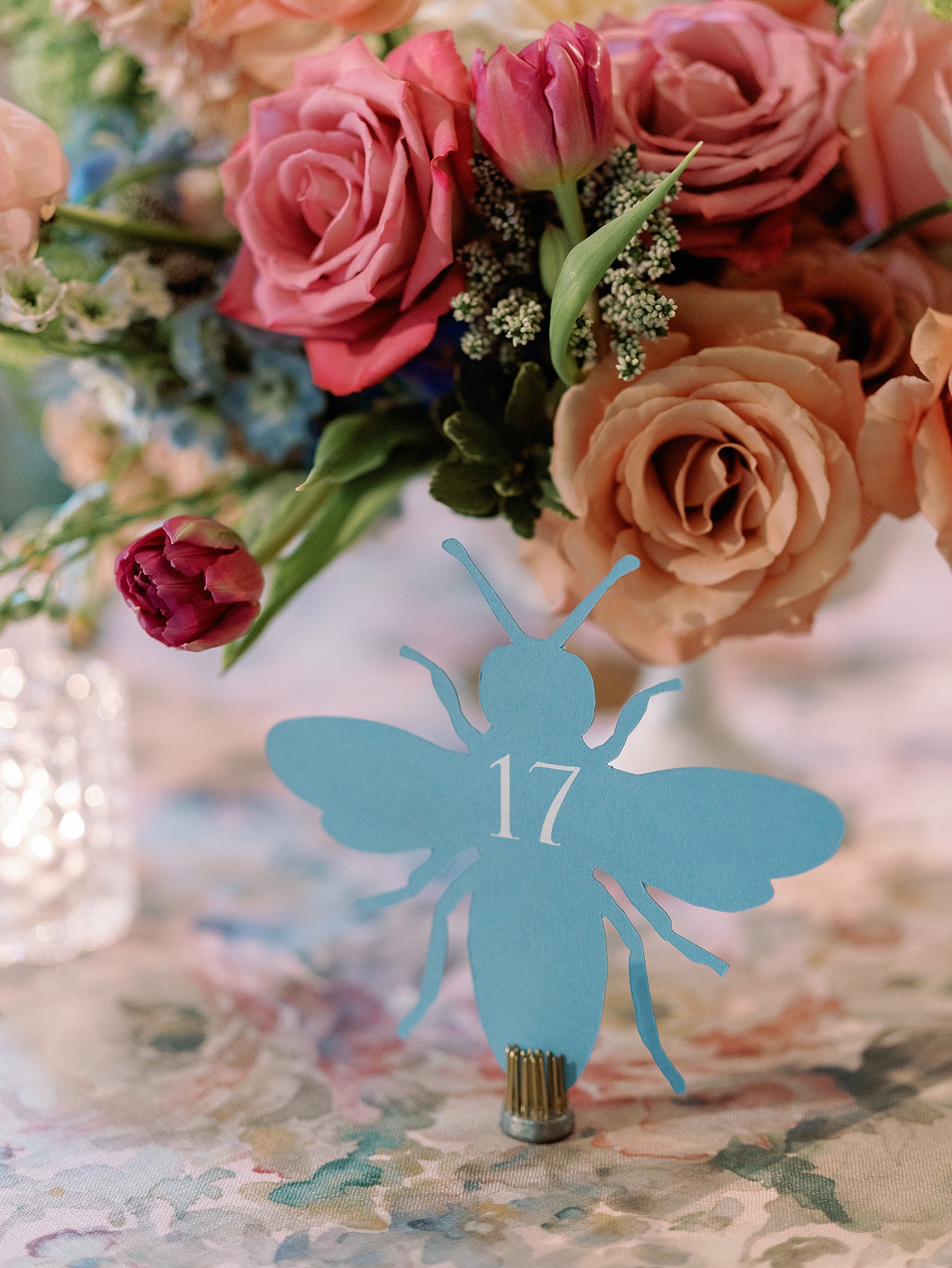 Blue dragonfly table number at a wedding