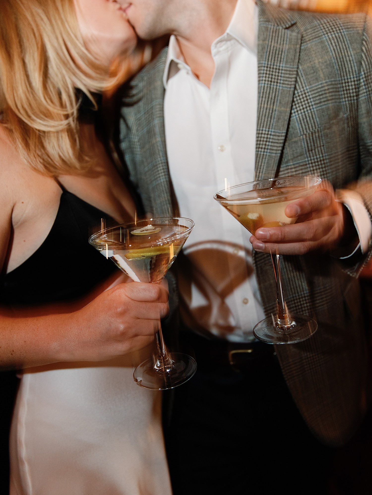 A blurry photo of two martini glasses held by a couple at Bones in Atlanta