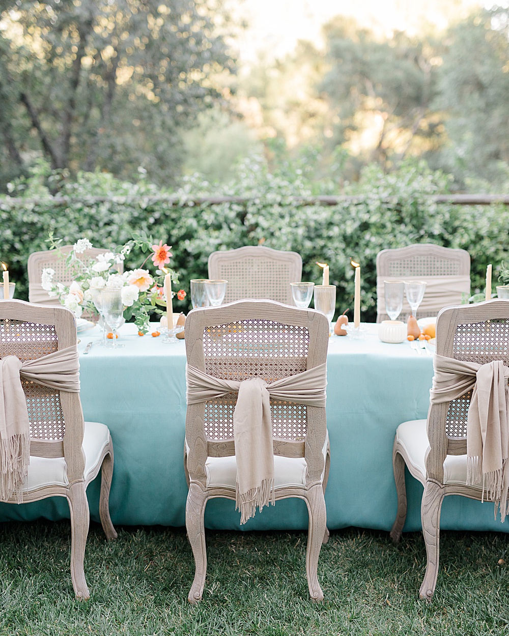 scarves wrapped around chairs for a rehearsal dinner