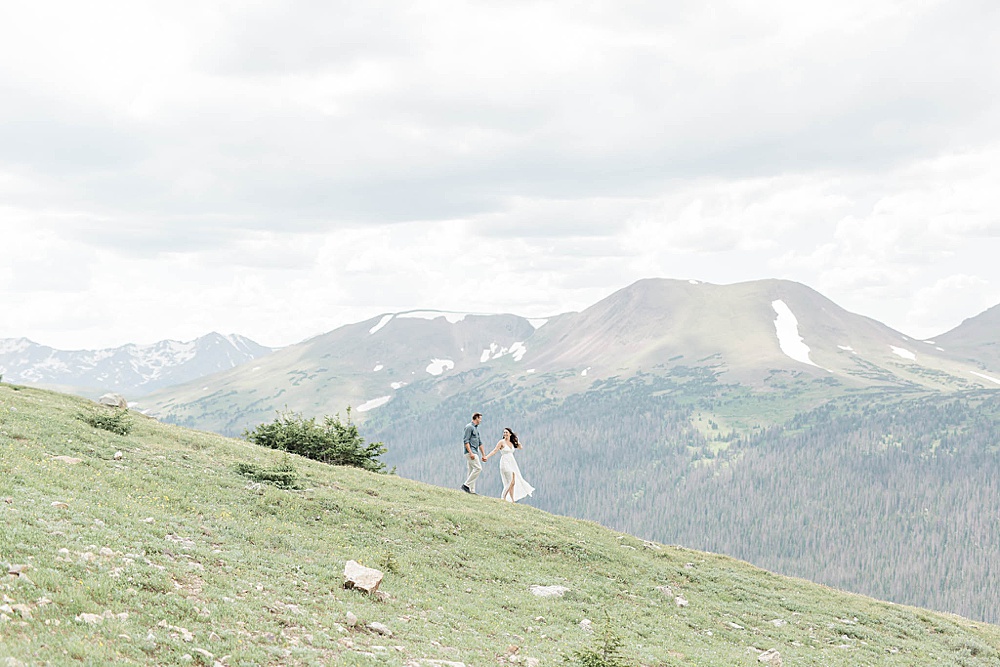engaged couple on a mountain in colorado