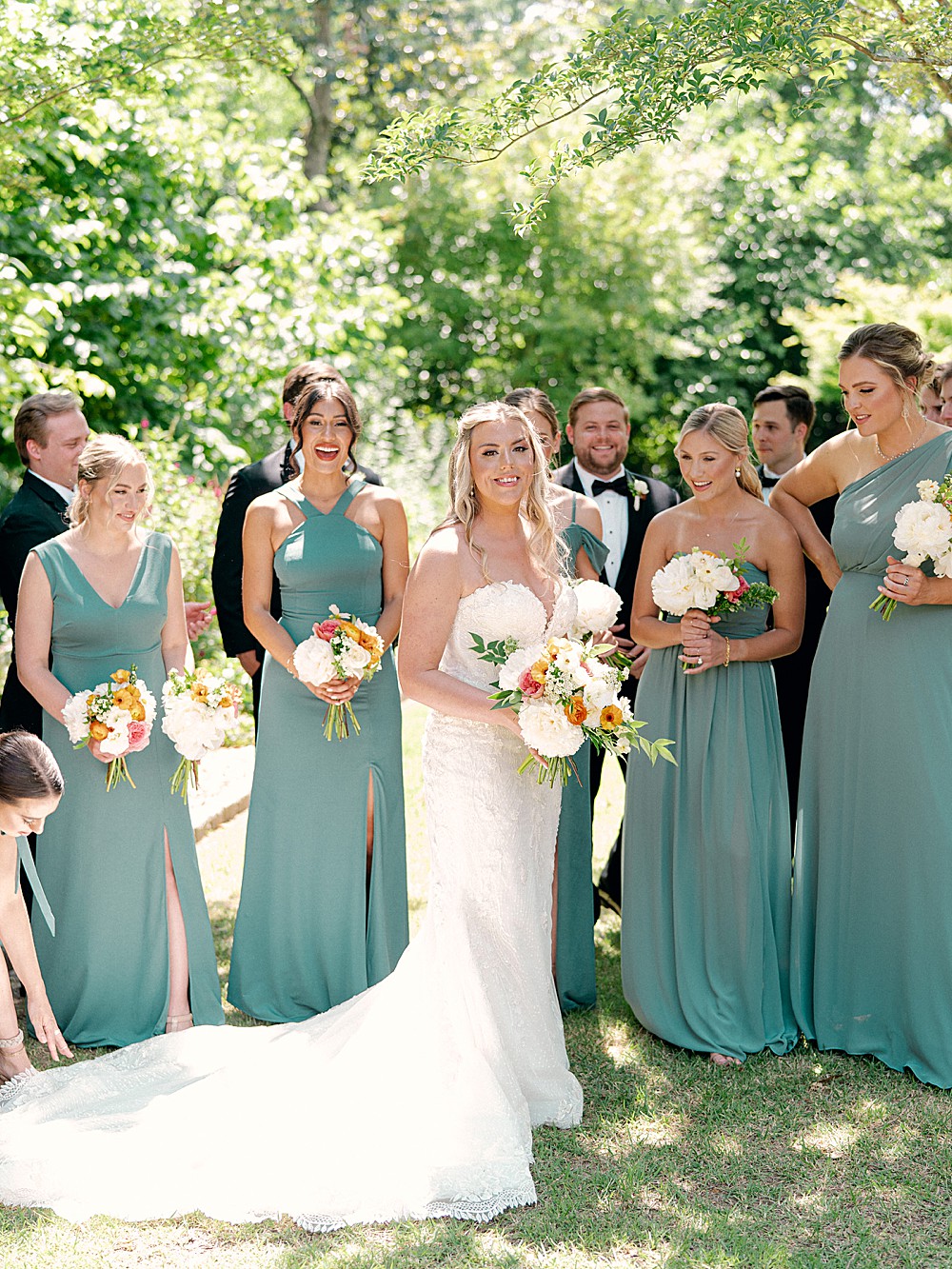 Bride with bridesmaids in jade green dresses in the gardens of Callanwolde Estate