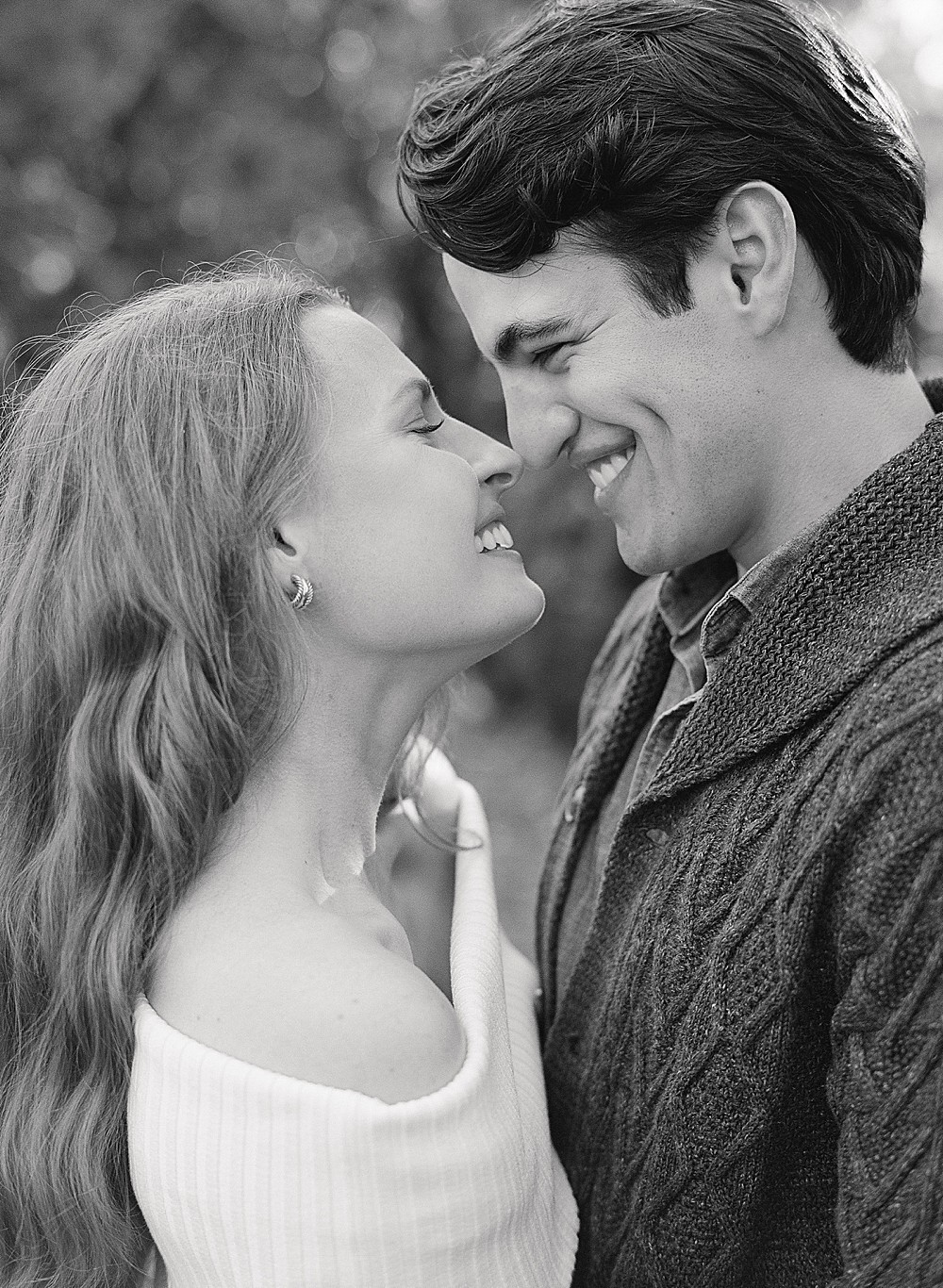 Black and white portrait of an engaged couple nose to nose