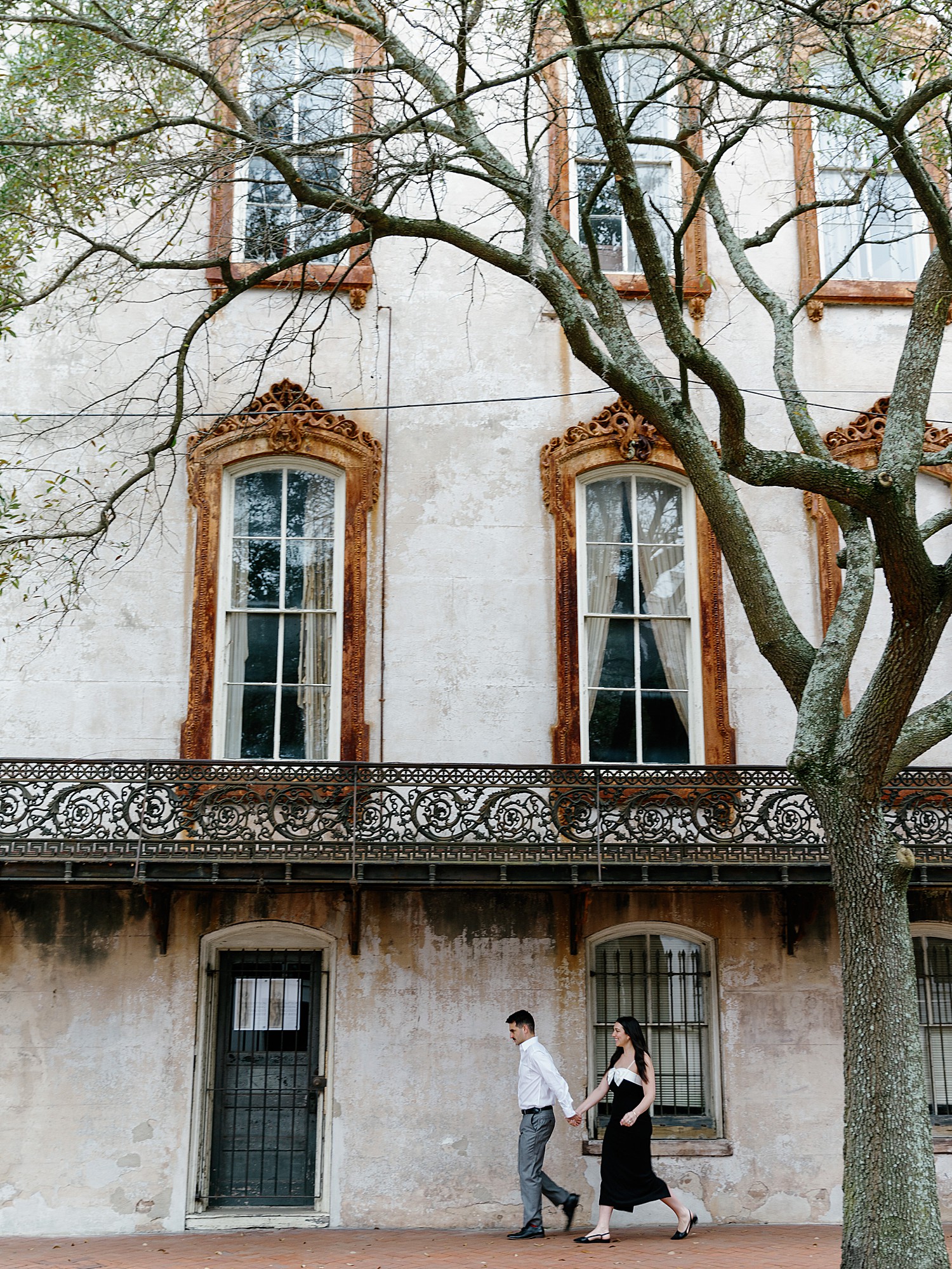 Couple walking in Monterey Square in Savannah, Georgia near Griffin Antiques