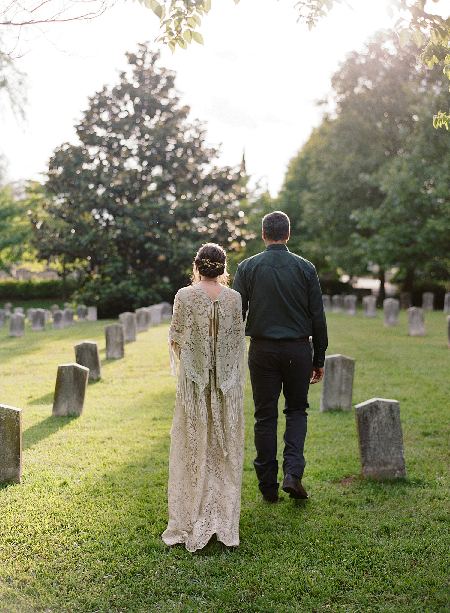 The engaged couple walks through the historic graveyard at Oakland Cemetery.